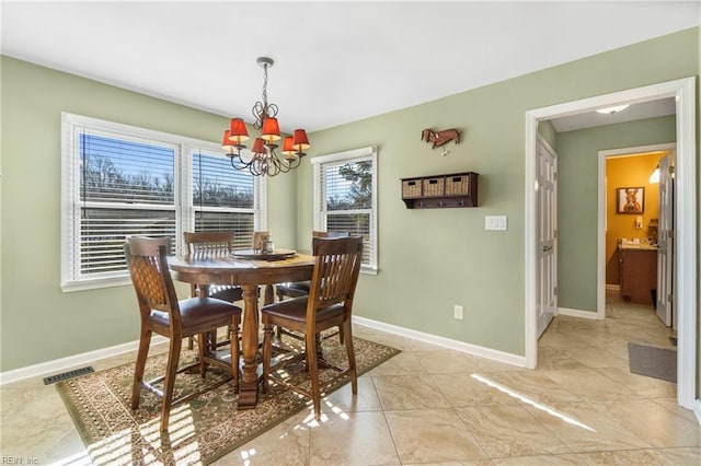 dining room featuring visible vents, baseboards, and a chandelier