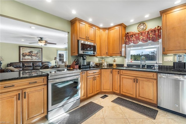 kitchen featuring a sink, appliances with stainless steel finishes, open floor plan, and recessed lighting