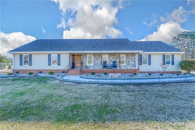 ranch-style home with a front yard, a porch, and roof with shingles