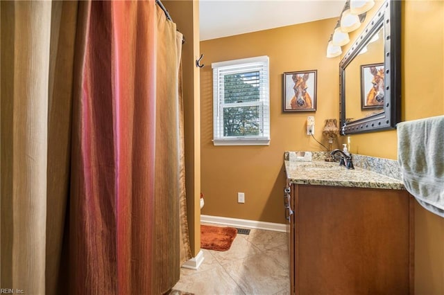 full bath with tile patterned floors, baseboards, toilet, and vanity