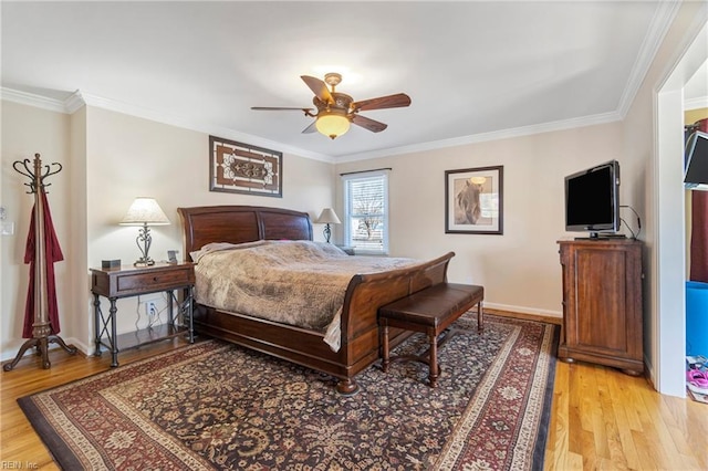 bedroom featuring light wood-type flooring, baseboards, a ceiling fan, and crown molding