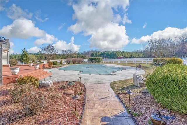 view of swimming pool featuring a patio area, a fenced in pool, and fence