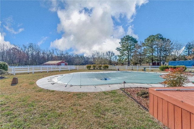 view of pool featuring a yard, a patio, a fenced in pool, and fence