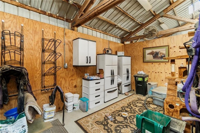 interior space featuring vaulted ceiling and metal wall