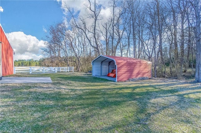 view of yard featuring a carport and fence