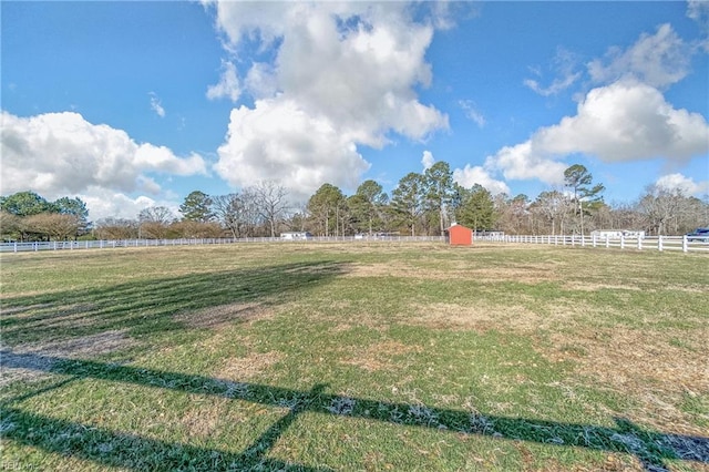 view of yard featuring a rural view and fence