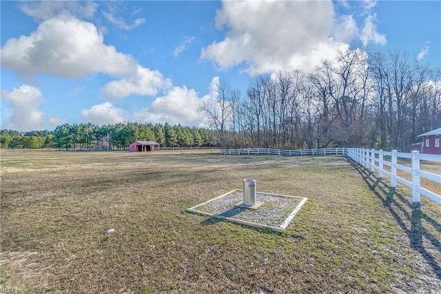 view of yard with a forest view, a rural view, and fence