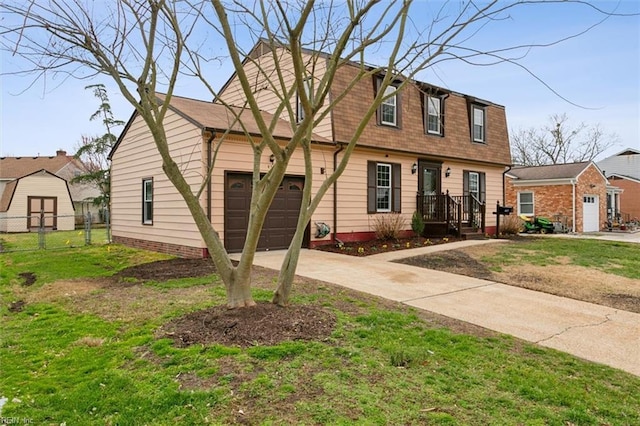 view of front facade with a front lawn, driveway, fence, a shingled roof, and a garage