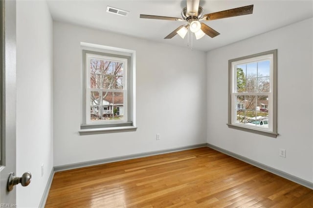 empty room with visible vents, baseboards, and light wood-style flooring