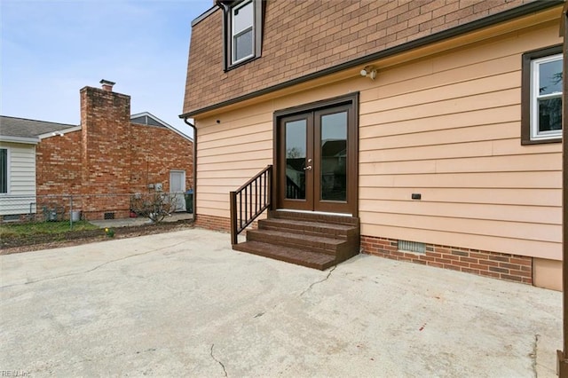 back of house with crawl space, a patio, roof with shingles, and entry steps