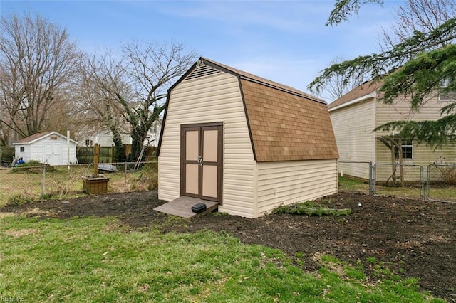 view of shed with a gate and a fenced backyard