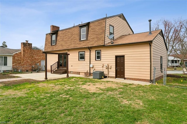 rear view of house featuring entry steps, a patio, a yard, and fence