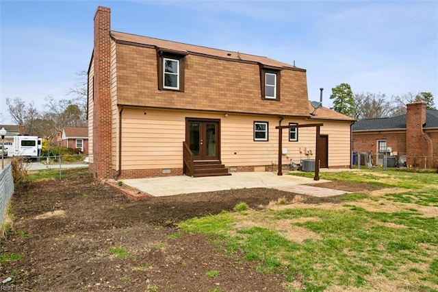 rear view of house with a patio, a fenced backyard, french doors, crawl space, and a chimney