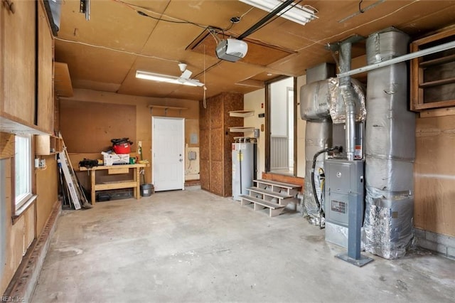 garage with gas water heater and a garage door opener