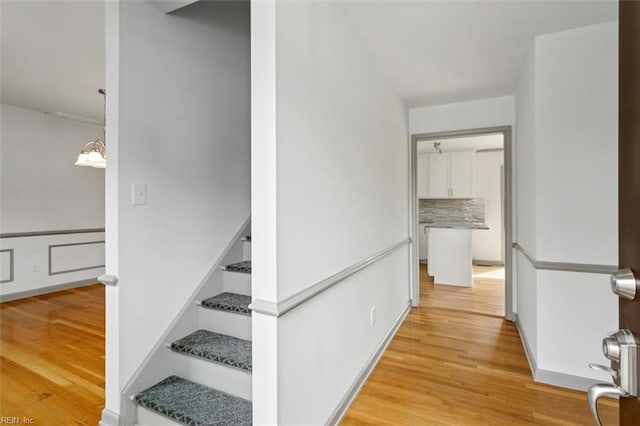 staircase with wood finished floors