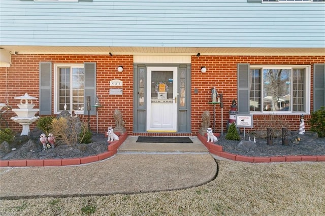 property entrance featuring brick siding