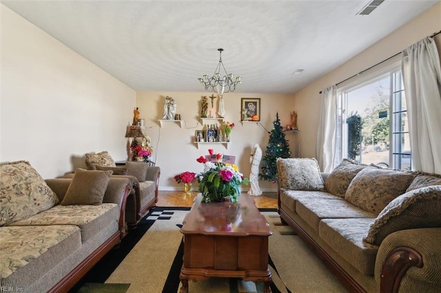 living room with visible vents and an inviting chandelier