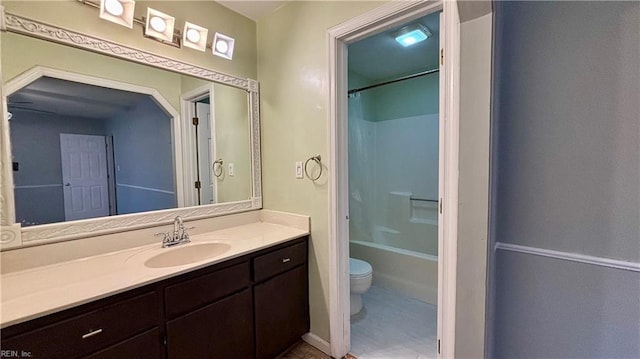 bathroom with vanity,  shower combination, and toilet