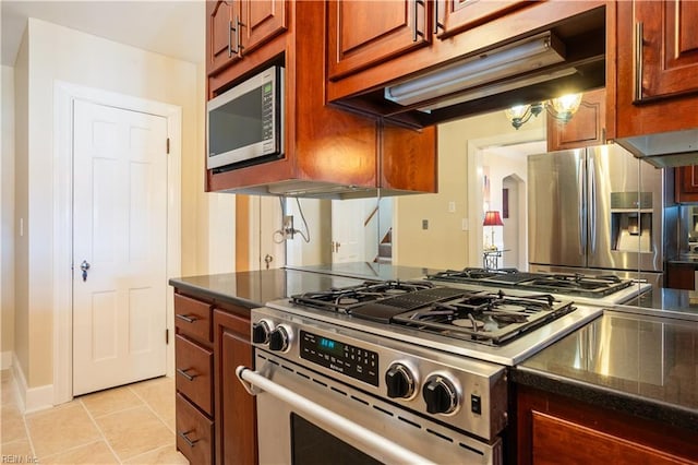 kitchen featuring light tile patterned floors and stainless steel appliances