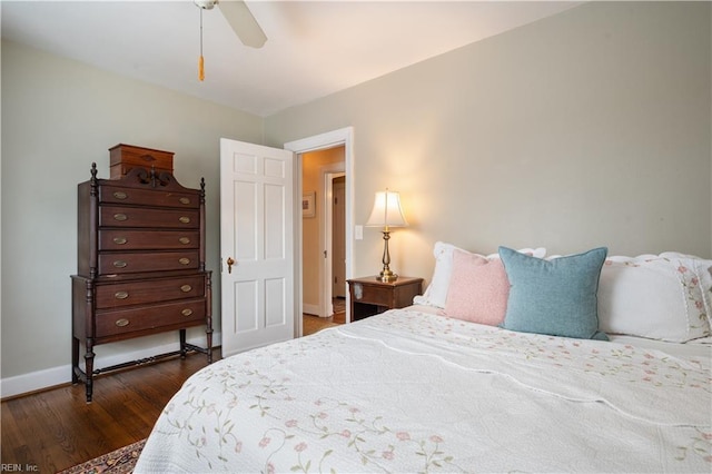 bedroom featuring a ceiling fan, baseboards, and dark wood-style flooring