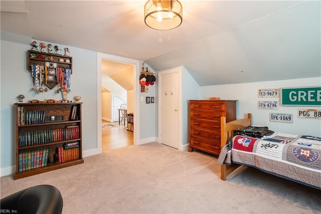 bedroom featuring vaulted ceiling, baseboards, and carpet floors