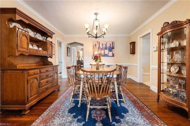 dining area featuring a chandelier, baseboards, dark wood-style floors, and ornamental molding