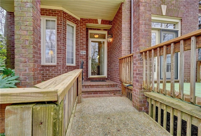 entrance to property featuring brick siding