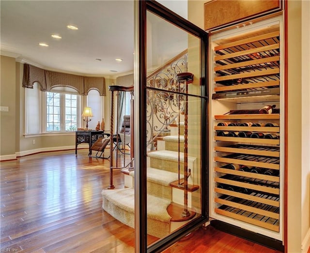 wine area featuring recessed lighting, wood finished floors, and baseboards