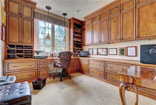 office space with light colored carpet and built in desk