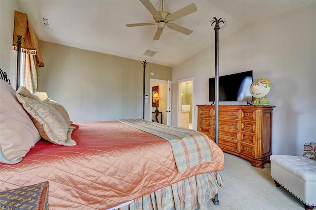 carpeted bedroom featuring vaulted ceiling, visible vents, ensuite bathroom, and ceiling fan