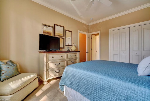 carpeted bedroom with a closet, a ceiling fan, and crown molding