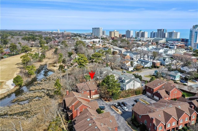 birds eye view of property with a city view and a water view