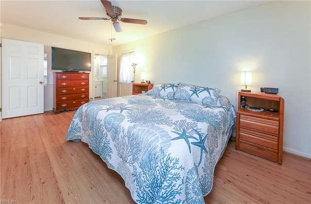 bedroom with a ceiling fan, wood finished floors, and baseboards