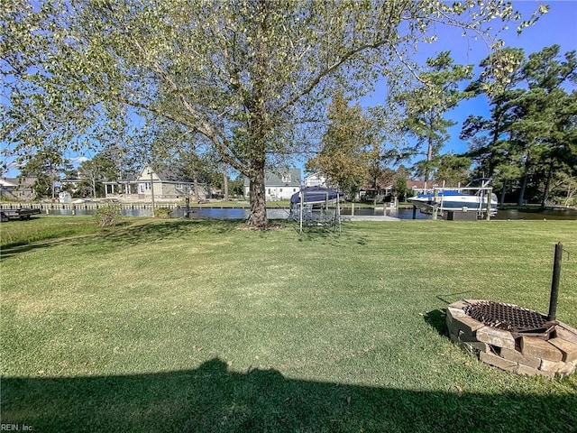 view of yard featuring a boat dock and a water view