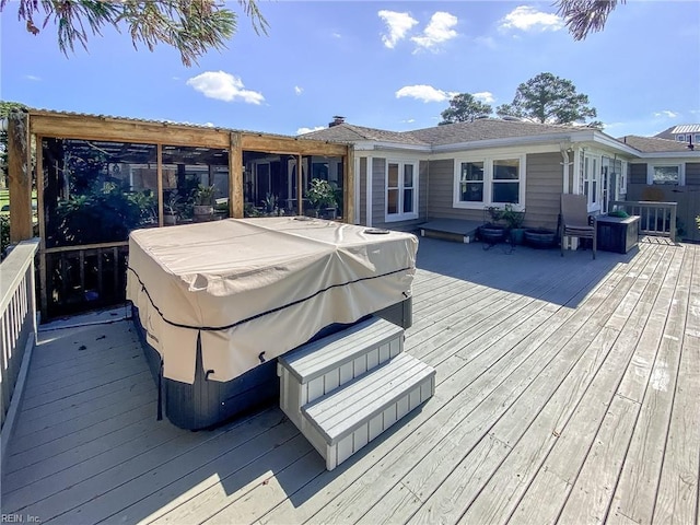 wooden deck with a hot tub