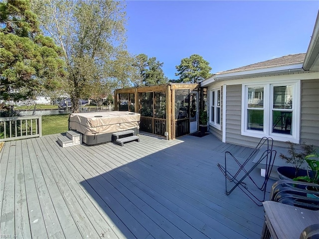 wooden deck with a hot tub