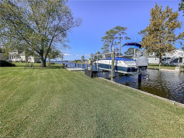 view of dock with a lawn, a water view, and boat lift