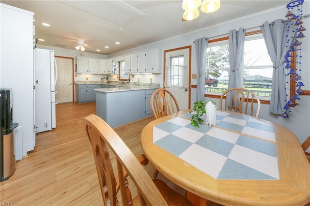 dining area featuring recessed lighting, attic access, light wood-style flooring, and ornamental molding