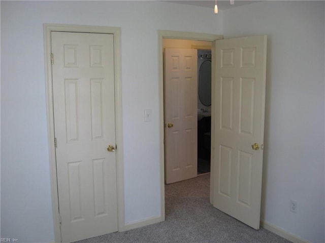 unfurnished bedroom with carpet and baseboards