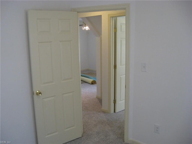 hall featuring baseboards and carpet floors