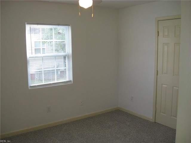 carpeted spare room with baseboards