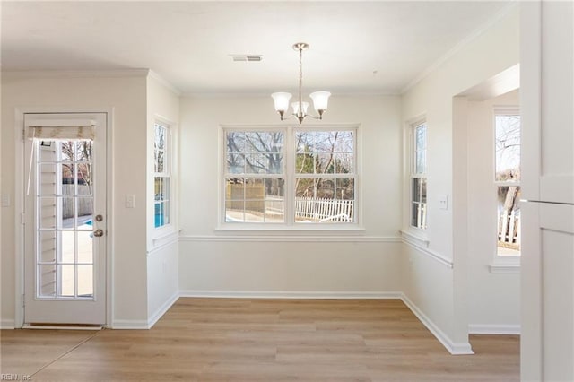 unfurnished dining area with visible vents, crown molding, and light wood-style floors