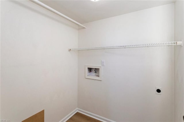 clothes washing area with wood finished floors, baseboards, hookup for an electric dryer, hookup for a washing machine, and laundry area