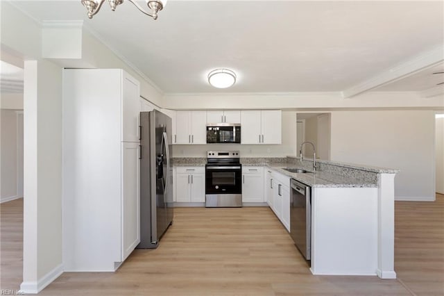 kitchen with light wood-style flooring, a sink, white cabinetry, appliances with stainless steel finishes, and light stone countertops