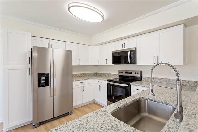 kitchen with crown molding, light stone counters, appliances with stainless steel finishes, and a sink