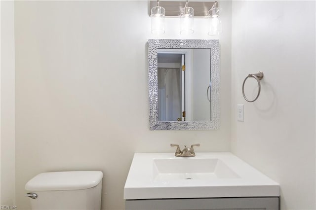 half bath featuring toilet and vanity