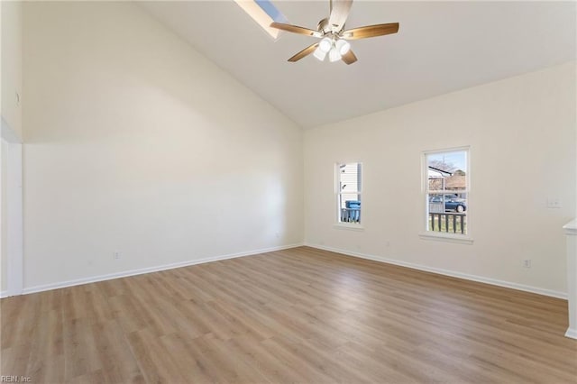 empty room with light wood-type flooring, baseboards, high vaulted ceiling, and a ceiling fan