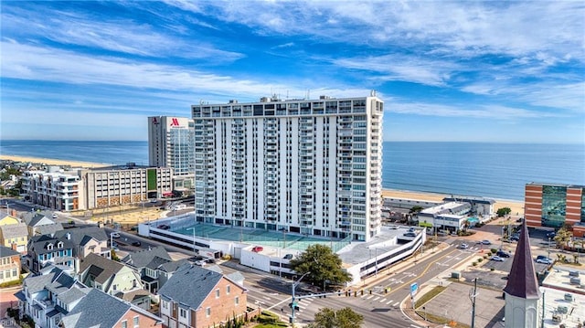 drone / aerial view featuring a water view and a view of city