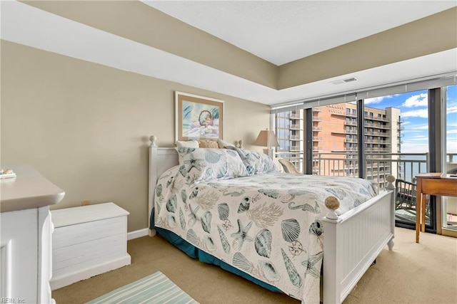 bedroom featuring access to outside, light colored carpet, visible vents, and baseboards