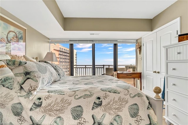 bedroom with visible vents, a closet, and access to outside